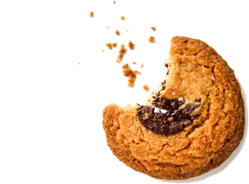 A cookie with one bite taken out of it, crumbs scattered around